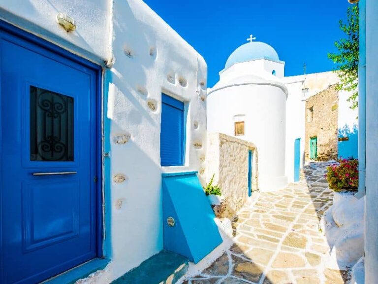 Traditional street in Lefkes Paros with white houses and blue doors